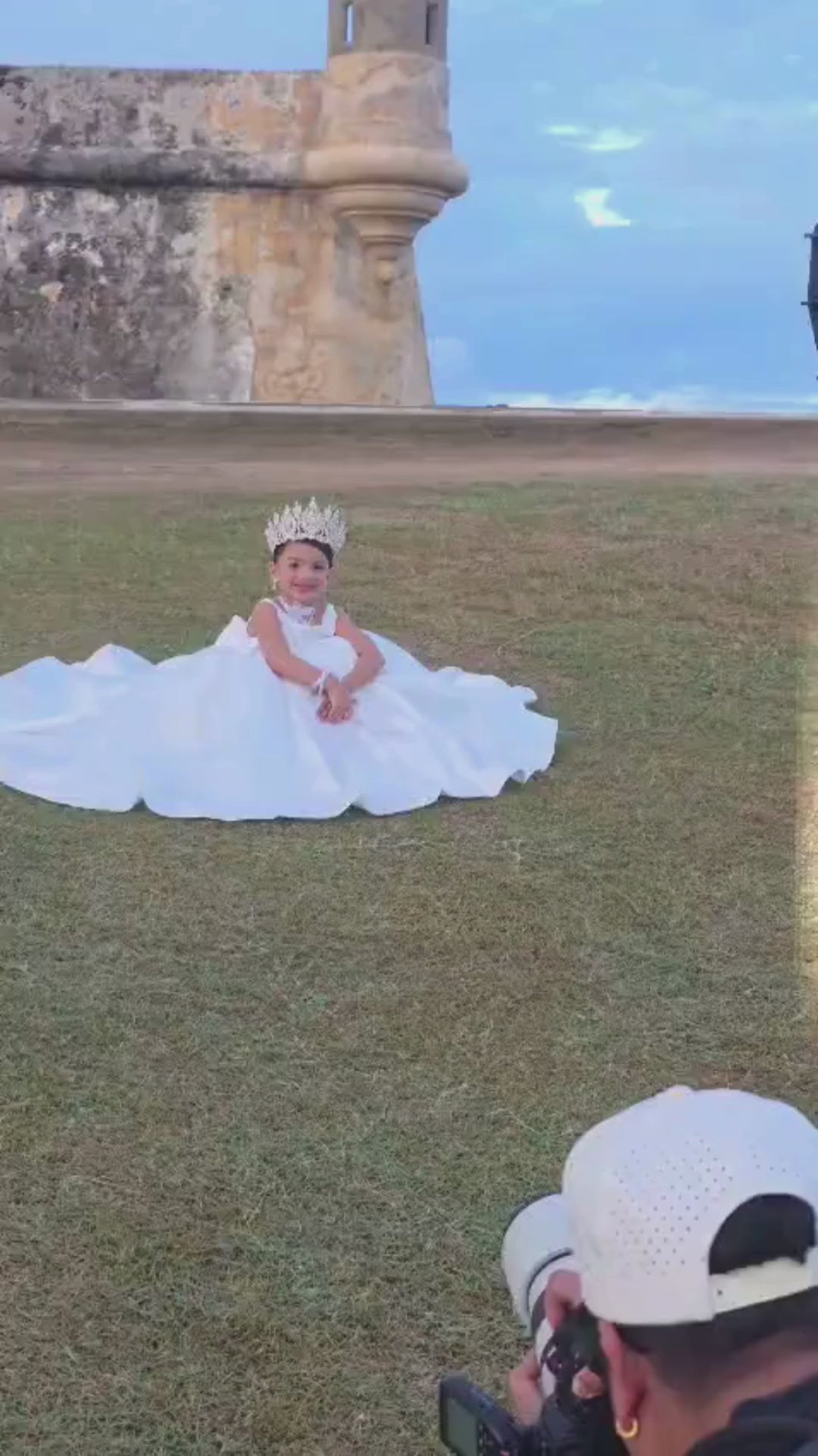 Back view of white communion ball gown with oversized bow