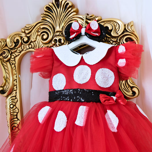 a red dress with white polka dots and a red bow