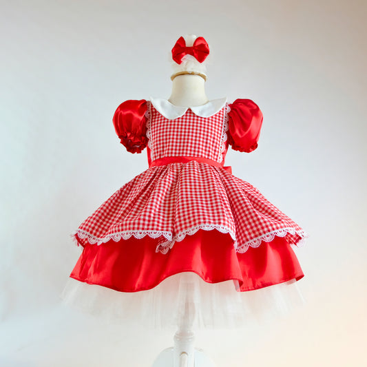a little girl's red and white dress on a mannequin