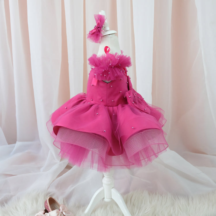 a little girl's pink dress and shoes on a mannequin