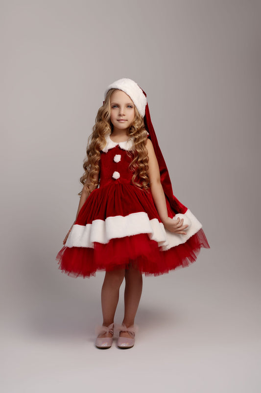 a little girl dressed up as santa clause