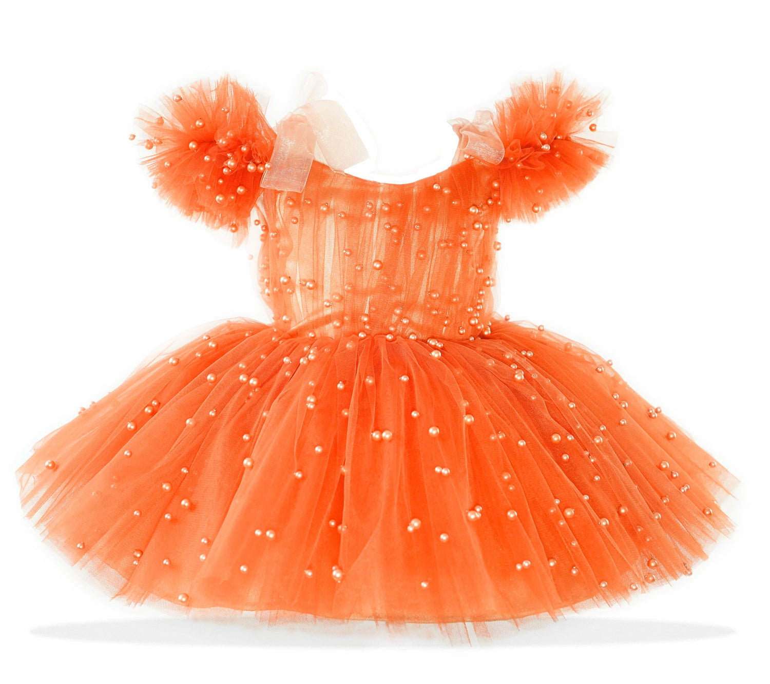 a little girl's orange dress with white dots