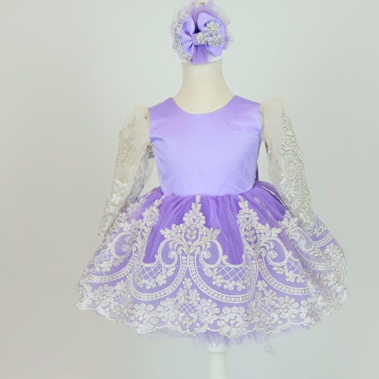 a little girl's purple and white dress on a mannequin