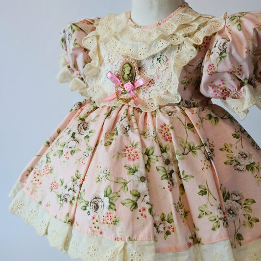 a pink dress with a flowered design on it