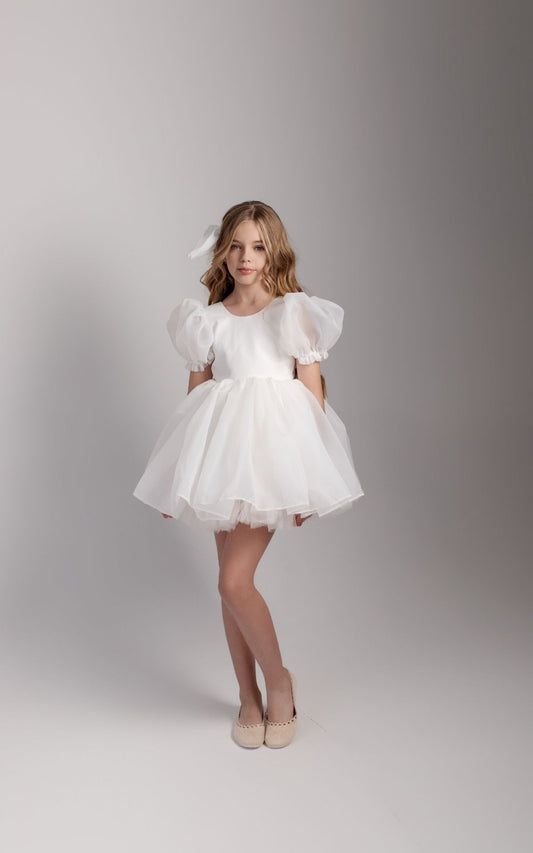 a little girl in a white dress posing for a picture Baby Girl Dress