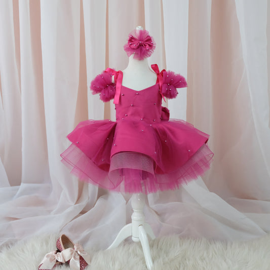 a little girl's pink dress and shoes on a mannequin