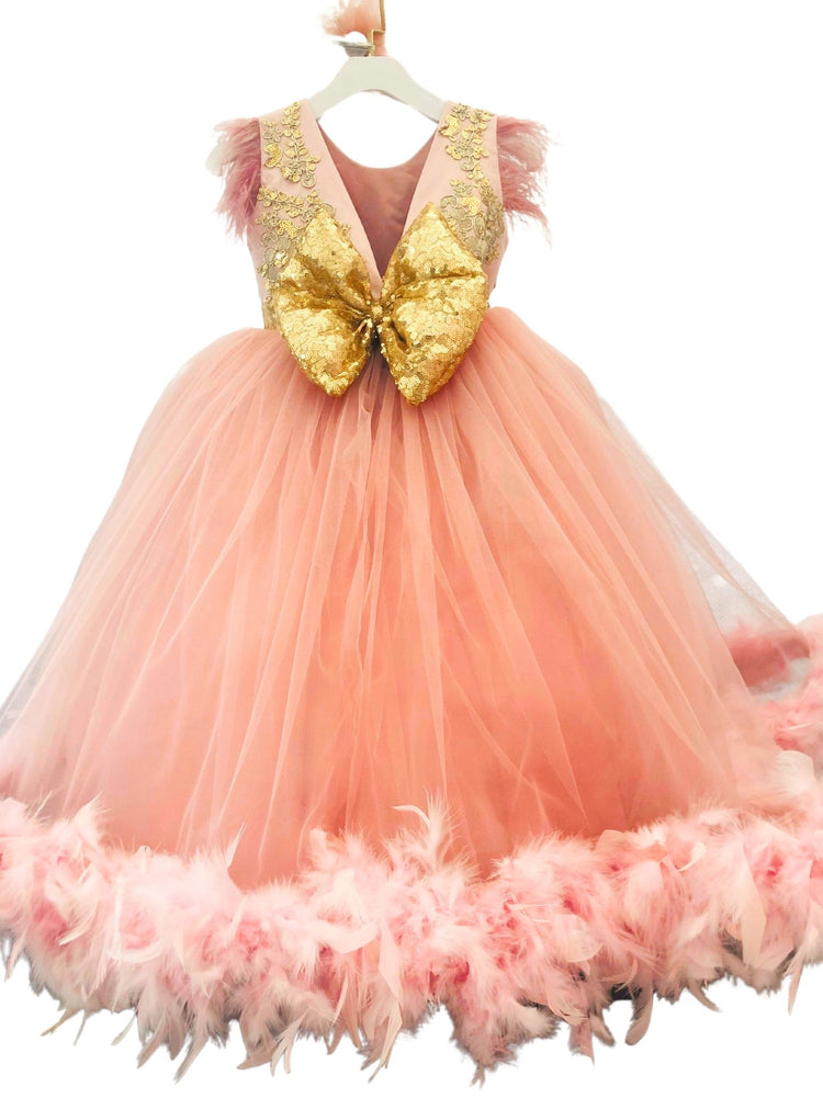 a pink dress with gold sequins and feathers