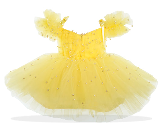 a yellow dress with pearls on it