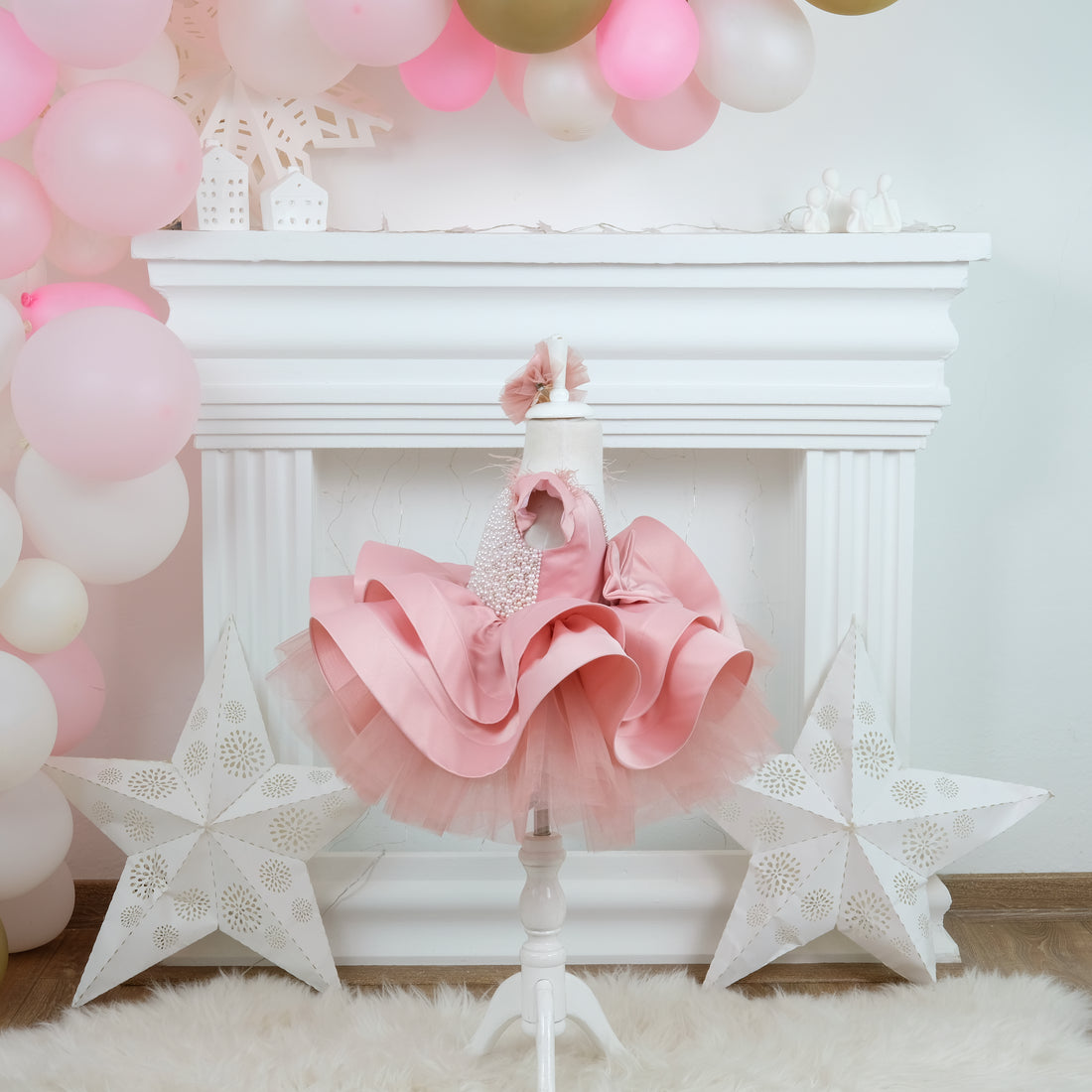a baby girl's pink and white dress and star decorations Baby Girl Dress for Special Occasion