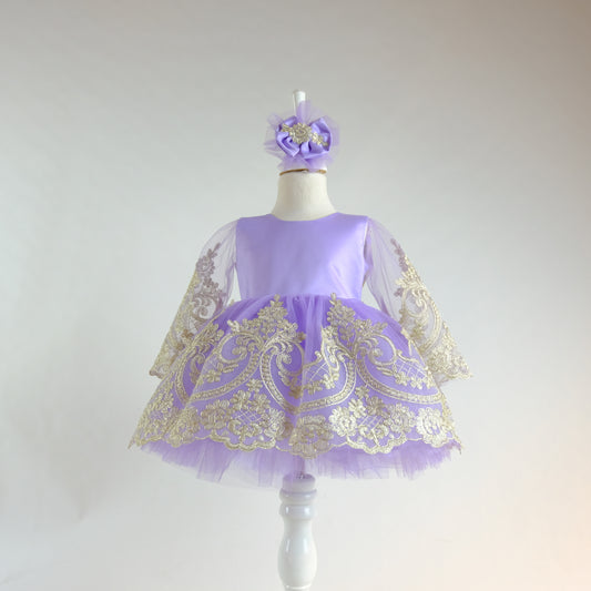 a little girl's purple and gold dress on a mannequin