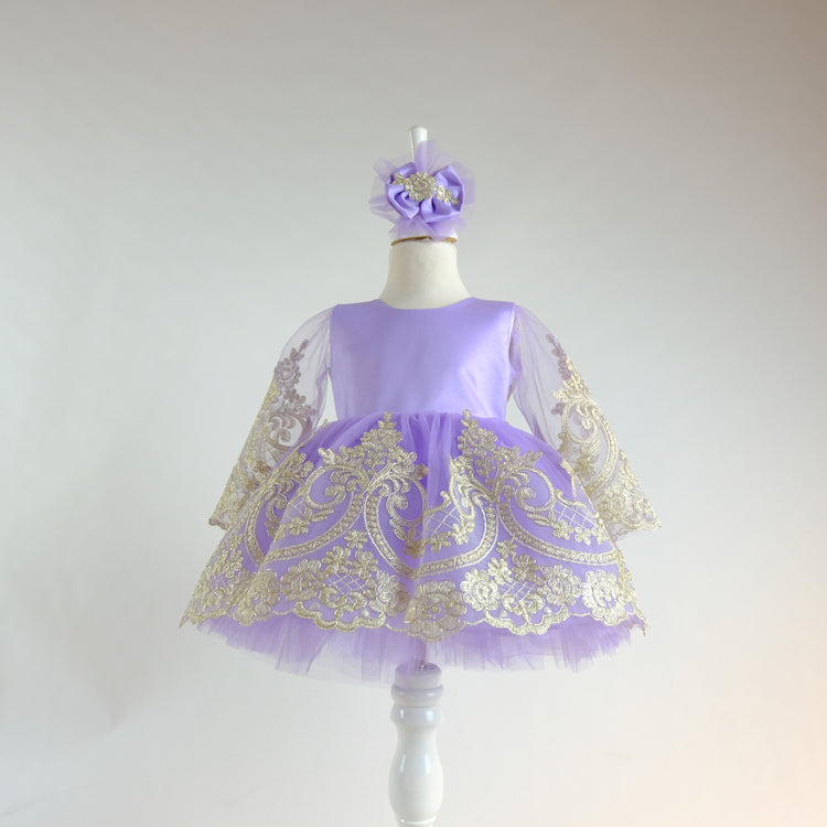 a little girl's purple and gold dress on a mannequin