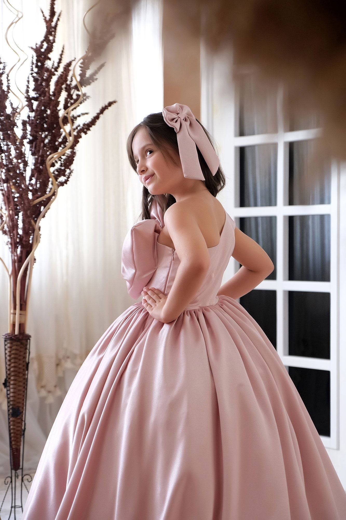 a woman in a pink dress posing for a picture