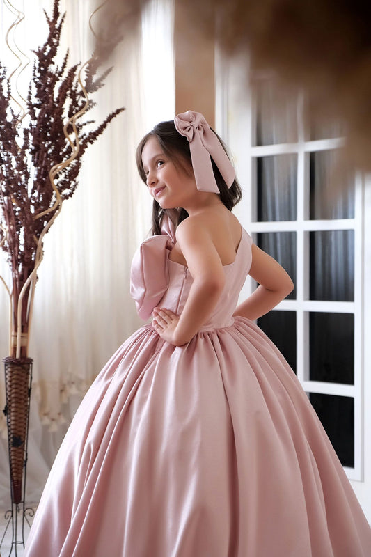 a woman in a pink dress posing for a picture
