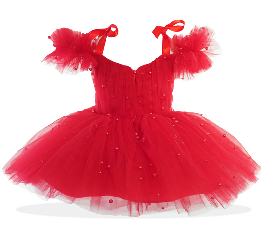 a little girl's red dress with a red bow