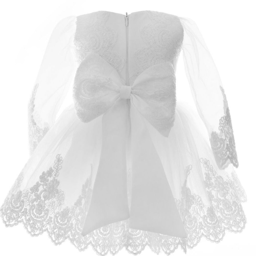 a white dress with a bow on it