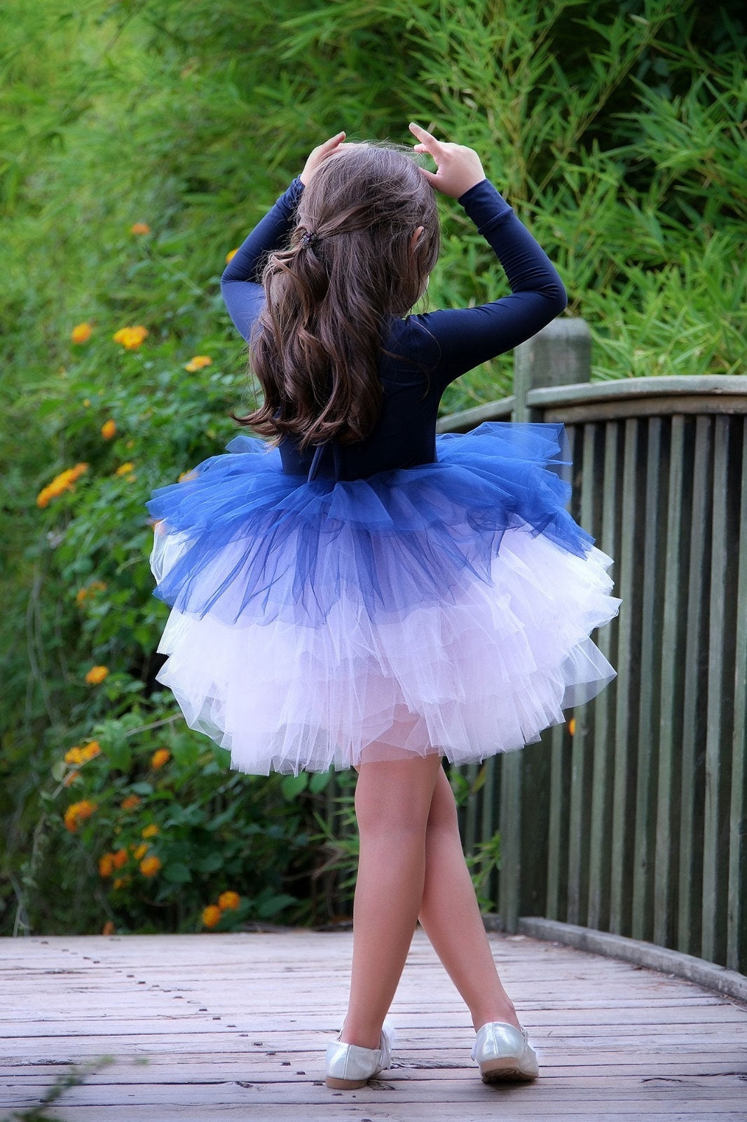 a little girl in a blue and white dress